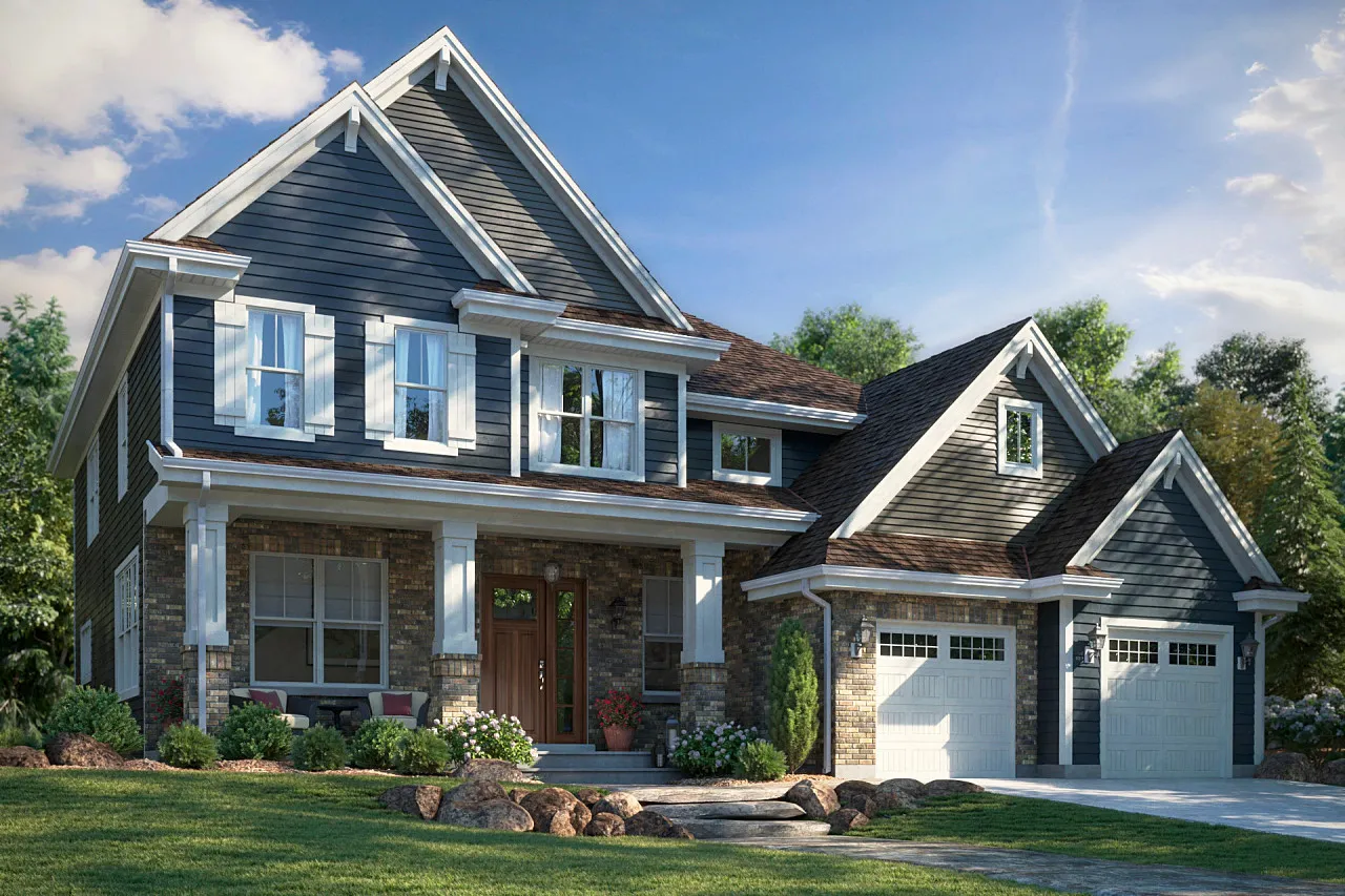Two-story house with dark gray siding, white trim, brick lower facade, a front porch with seating, and a double garage under a blue sky.